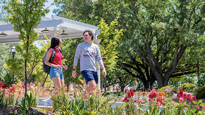 Two students walking across campus.